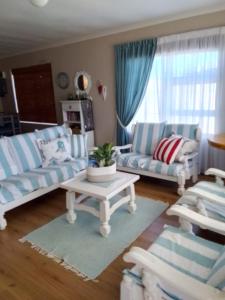 Una sala de estar con dos sofás y una mesa de café. en Geelstert 25, en Struisbaai