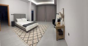 a bedroom with a bed and a rug at Rumays House, Barka in Rumays +29 photos