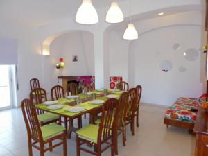 a dining room with a table and chairs and a fireplace at Vital by Check-in Portugal in Albufeira