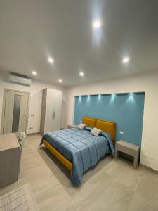 a bedroom with a bed and a blue wall at Casa Franco in Sant'Agnello