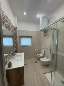 a bathroom with a shower and a sink and a toilet at Casa Franco in Sant'Agnello +2 photos