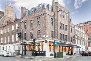 a large brick building on the corner of a street at London Paddington Apartments in London