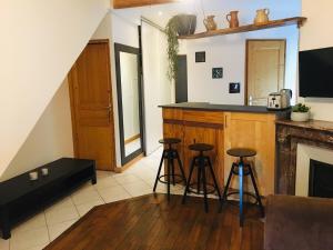 a kitchen with two bar stools and a counter at Apartment Saclay 1 Close to HEC, CEA, Versailles in Saclay +10 photos