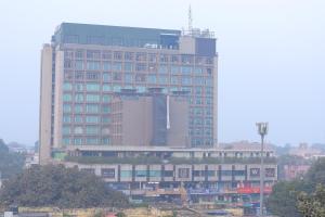 a large building with a lot of windows at Vibha Raj Grand in Kānpur