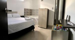 a bedroom with a bed and a bath tub at Hotel La Herradura in Puerto López +25 photos