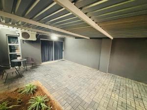 an empty room with a table and chairs in it at Nettle Nest Accommodation in Polokwane +2 photos
