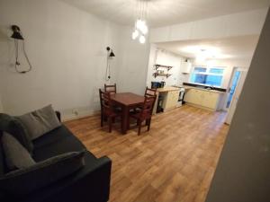a living room with a couch and a table and a kitchen at Double-Bed Manchester Close To Bolton City Centre C2 in Little Hulton +5 photos