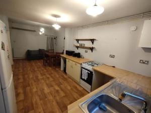 a kitchen with a sink and a stove top oven at Double-Bed Manchester Close To Bolton City Centre C2 in Little Hulton
