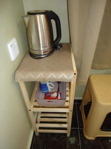a pot sitting on top of a small table at Kirana Guestroom in Kuala Tahan +21 photos