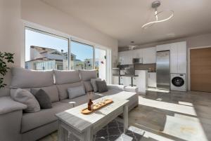 a living room with a couch and a table at Stunning Beachfront Penthouse in Estepona