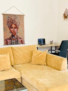 a couch in a living room with a painting on the wall at Pepper House with pool in Argaka