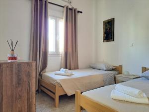Postel nebo postele na pokoji v ubytování Guest House Alepou Leros