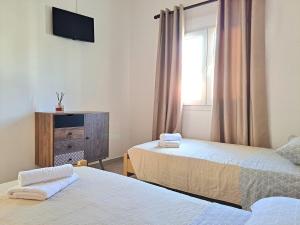 Postel nebo postele na pokoji v ubytování Guest House Alepou Leros