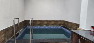a swimming pool in the middle of a room at Gotawala Villa 11 in Daman