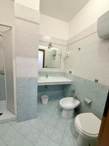 a bathroom with a toilet and a sink and a mirror at Hotel Dania in Sorrento