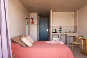 a bedroom with a bed with a pink blanket at Formentera Especial in La Savina
