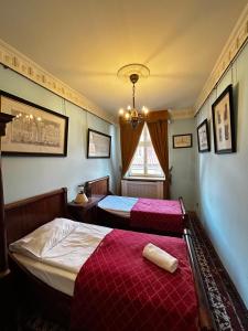 a bedroom with two beds and a window at Royal in Kraków