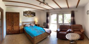 a bedroom with a bed and a couch at Domek w Las Bagnas in Konopki Małe