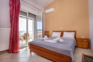 a bedroom with a bed with two towels on it at Villa Rafailia in Skala Marion