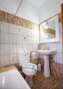 a bathroom with a toilet and a sink at Villa Rafailia in Skala Marion +28 photos