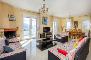 a living room with two couches and a fireplace at Villa Rafailia in Skala Marion