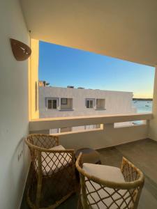 two chairs in a room with a large window at Formentera Especial in La Savina