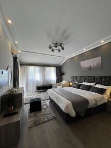 a bedroom with a large bed and a living room at Unique villa in madinaty in Madinaty