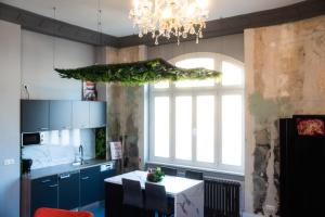 a kitchen with a table and a chandelier at Aue Stay in Kassel