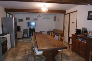 a kitchen and dining room with a wooden table at DOMAINE LE PLA de LIÉRE in Maury +20 photos