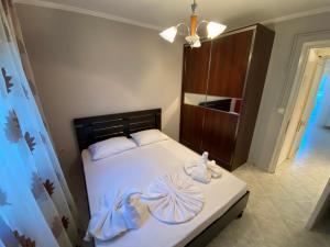 a bedroom with a bed with two towels on it at Paul House in Metamorfosi
