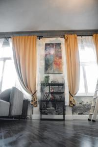 a living room with a couch and two windows at Aue Stay in Kassel +4 photos