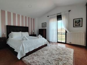 a bedroom with a bed and a large window at Villa Alilacha - Piscina Barbacoa Playa 500 m in Bueu +19 photos