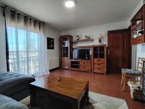 a living room with a couch and a coffee table at Villa Alilacha - Piscina Barbacoa Playa 500 m in Bueu