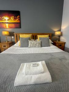 a hotel room with a bed with a white towel on it at The Corbet Arms in Shrewsbury