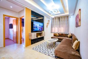 a living room with a couch and a tv at Migdal Calavon in Marrakech