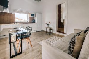 a living room with a couch and a table and a kitchen at Serenity House in Tinajo