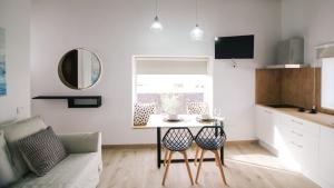 a small kitchen with a table and chairs in a room at Serenity House in Tinajo