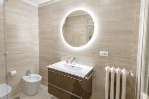 a bathroom with a sink and a mirror at Vatican Penthouse - Terrace with view in Rome +22 photos