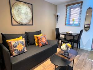 a living room with a couch and a table at Glastonbury Hidden Passage, Split Level 1 Bedroom Apt in Glastonbury