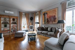 a living room with a couch and a table at Vatican Penthouse - Terrace with view in Rome