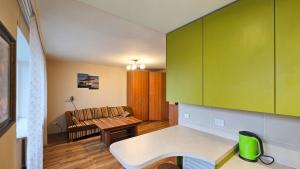 a living room with a couch and a table at Green room in Šiauliai