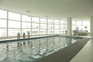 a large swimming pool in a large room with windows at BV0716 I Lindo Duplex no coração de São Paulo O Mais completo in Sao Paulo