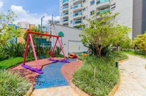 a playground with a swing set in a garden at BV0716 I Lindo Duplex no coração de São Paulo O Mais completo in Sao Paulo