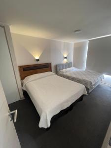イキケにあるCondominio Playa Huantajayaのベッドルーム1室(ベッド2台、壁に照明2つ付) +18枚の写真