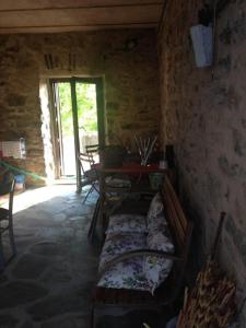 a room with two beds and a table and a window at La casa del bosco in Bagnone