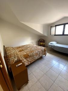 Postel nebo postele na pokoji v ubytování Attico Amelia Soverato Con Terrazzo e Barbecue