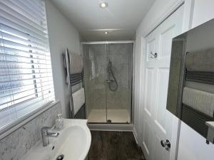 Un baño blanco con ducha y lavabo. en Hurstpier Spacious 2 Bed Apartment - by MCF, en Hurstpierpoint 31 fotos más