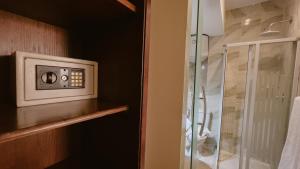 a bathroom with a microwave and a glass shower at Giza Pyramids Inn in Cairo +39 photos