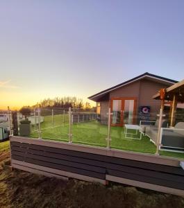 a house with a large deck with a lawn at Top Lodge in Newton Stewart +24 photos