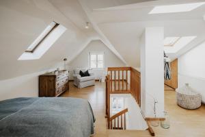 a attic bedroom with a bed and a staircase at Appartement no8 in Sankt Gilgen